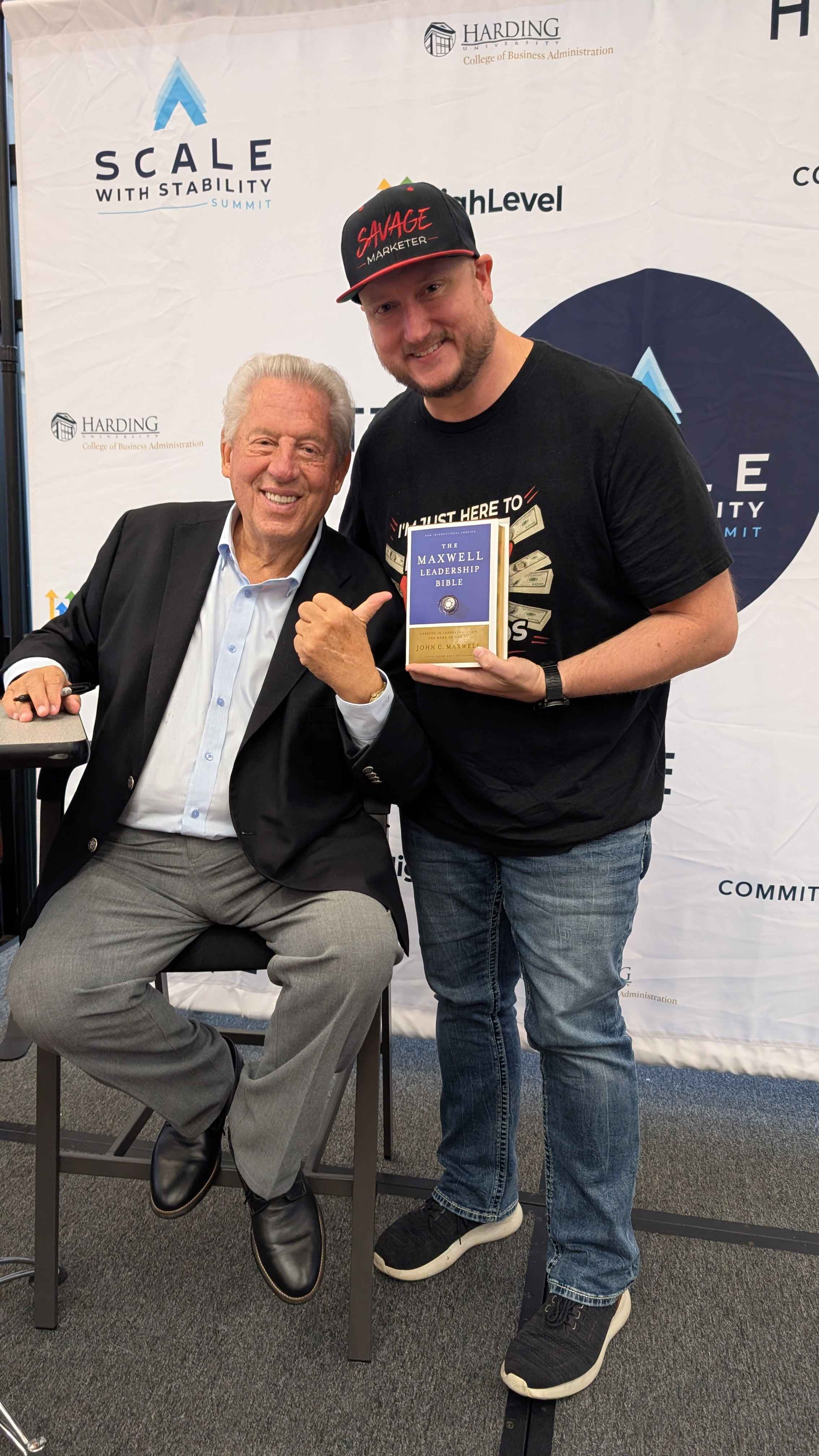 Jeff J Hunter with John C. Maxwell, holding a signed copy of The Maxwell Leadership Bible.